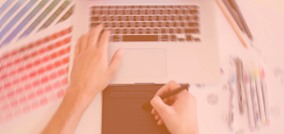 A brand and logo graphic design expert creating a brand identity on a laptop